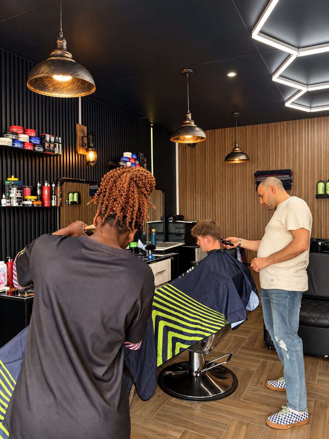Inside Excellent Barber — barbers at work under the hexagon lights